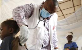 MSF emergency team doctor, examines a child