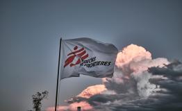 MSF flag waves with a blue sky in the background