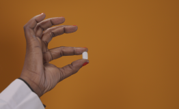 Person holding a pill