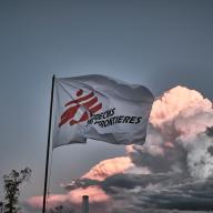 MSF flag waves with a blue sky in the background