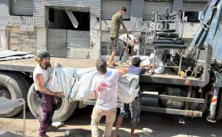 Five MSF staff load tents on to a truck in Gaza City