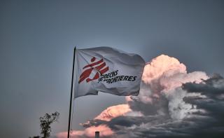 MSF flag waves with a blue sky in the background
