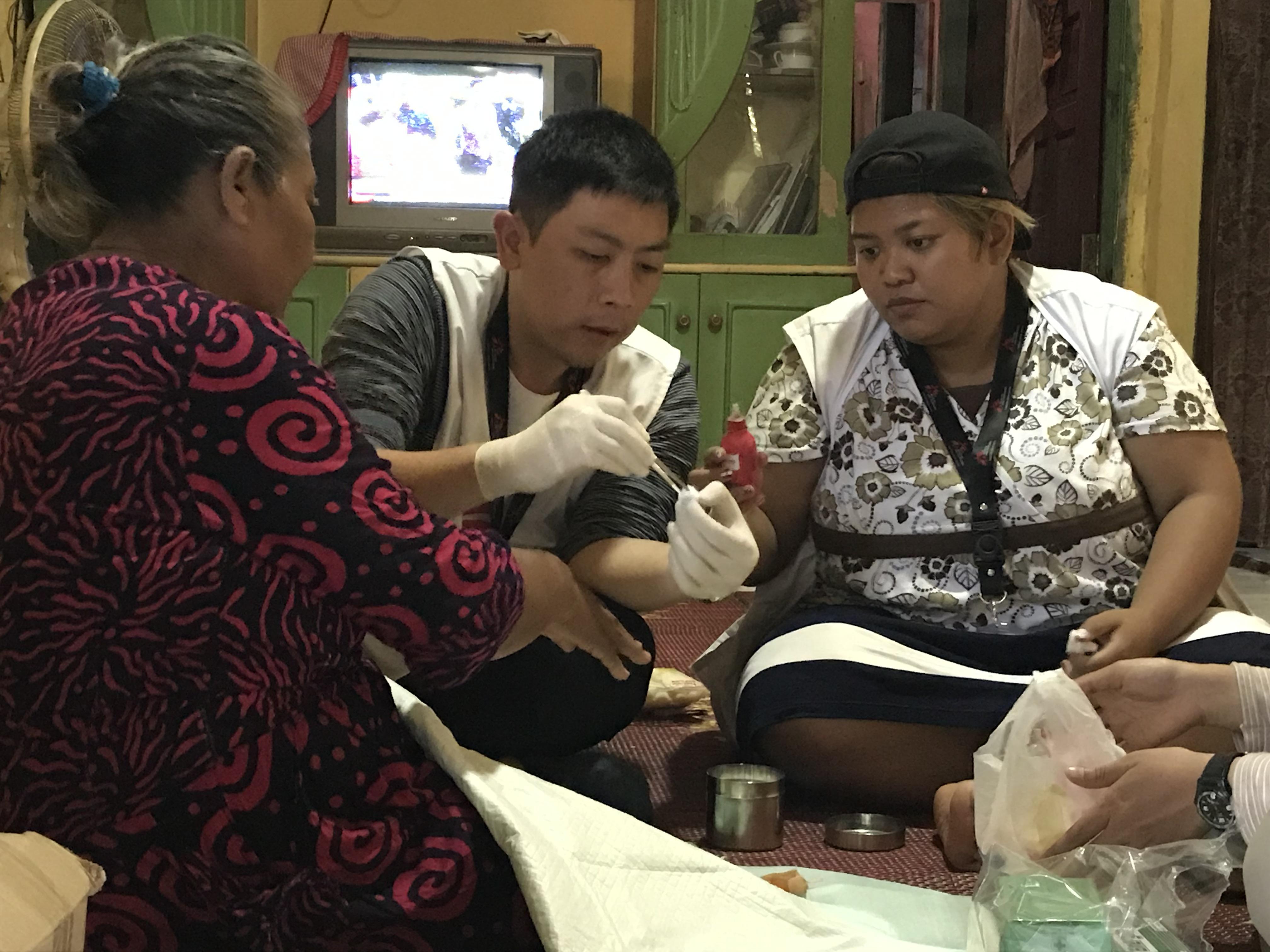 Dr Patrick Indradjaja with Elis' family in Cigondang village, Indonesia